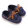 Navy blue baby first walker sneakers with brown fabric ties and white stitching