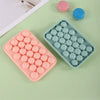 A silicone mold tray with round silicone grape clusters in pink and blue colors for soap and candle making