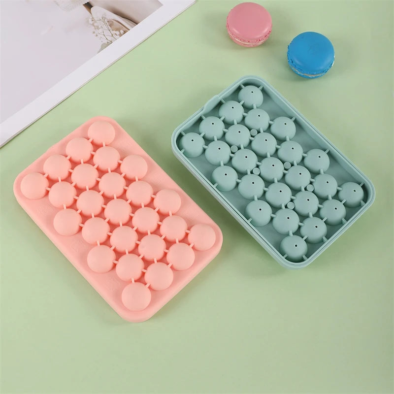A silicone mold tray with round silicone grape clusters in pink and blue colors for soap and candle making