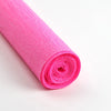 A roll of bright pink crepe paper for DIY crafts and gift wrapping.