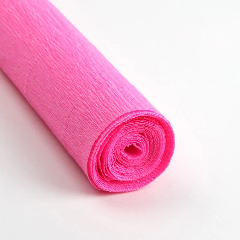 A roll of bright pink crepe paper for DIY crafts and gift wrapping.