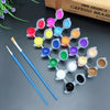 A set of twelve colored acrylic paint droppers and a brush are displayed on a dark surface.