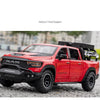 A red RAM Mammoth 1000 TRX diecast pickup truck model parked outdoors.