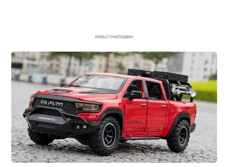A red RAM Mammoth 1000 TRX diecast pickup truck model parked outdoors.