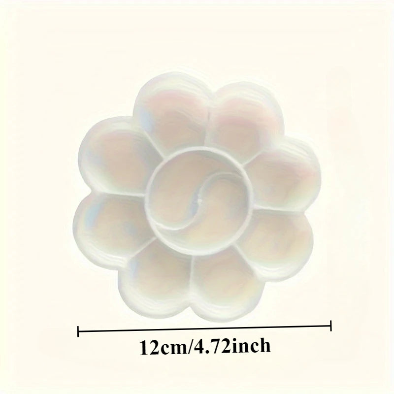 A close-up view of a flower-shaped disposable paint palette with a translucent white and pink hue.