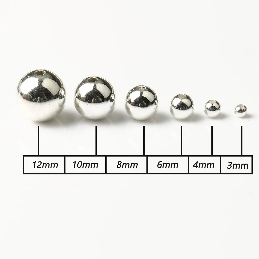 A row of round silver spacer beads of varying sizes, measured from 12mm down to 3mm.