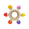 A silicone baby teether shaped like a rudder with a wooden ring and colorful silicone protrusions.