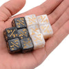 A hand holds a set of ten dual-color dice showing positive and negative numbers.