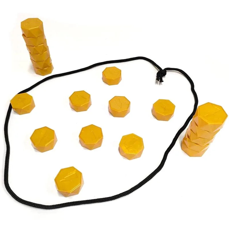 A set of yellow magnetic soccer strategy board game pieces arranged in a line and scattered on a white background.