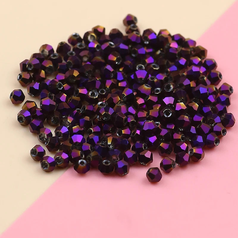 A pile of dark purple and violet electroplated crystal glass beads for jewelry making