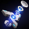 A silver metal luminous fidget spinner rotating in mid-air against a dark background.