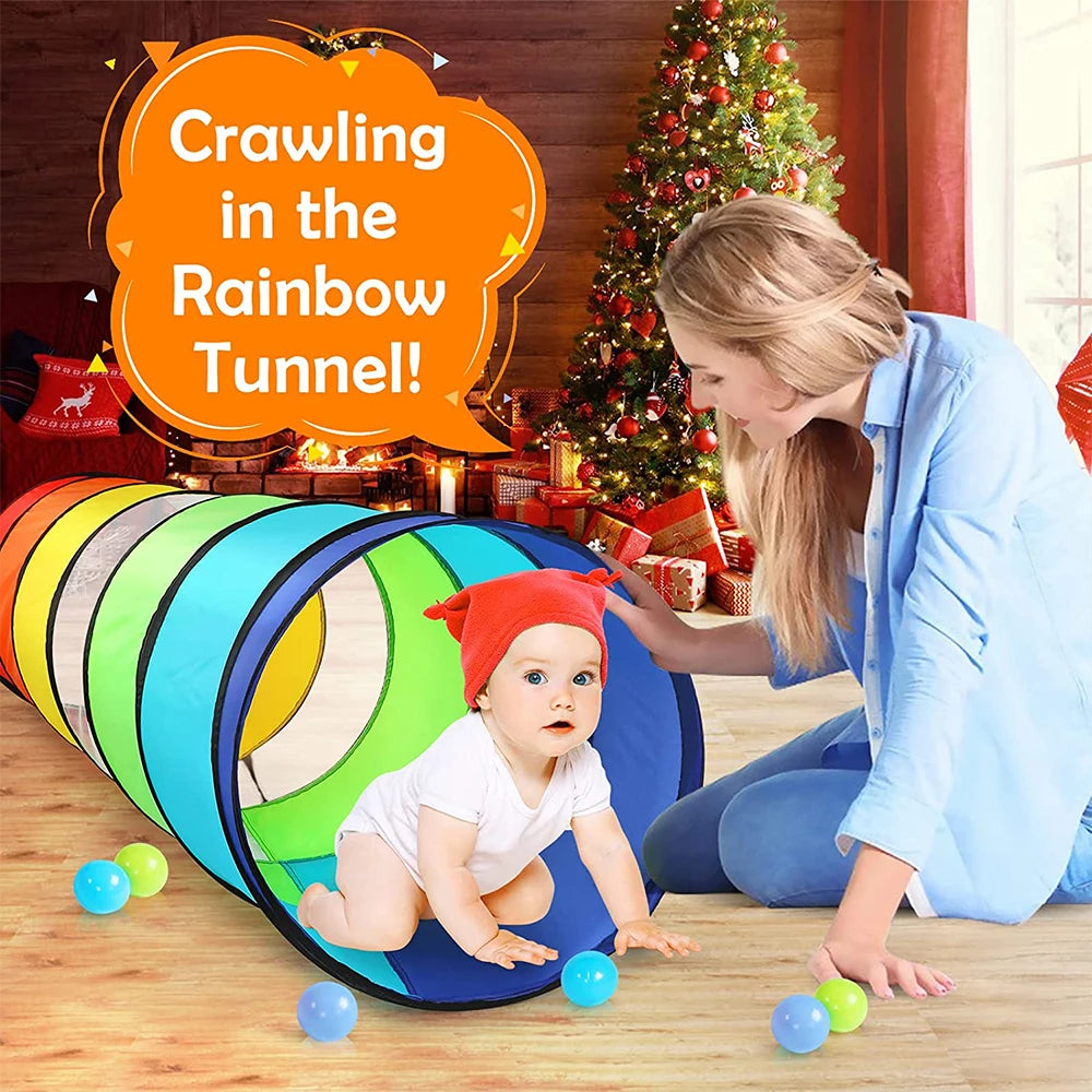 A baby is crawling through a colorful rainbow tunnel play structure indoors.