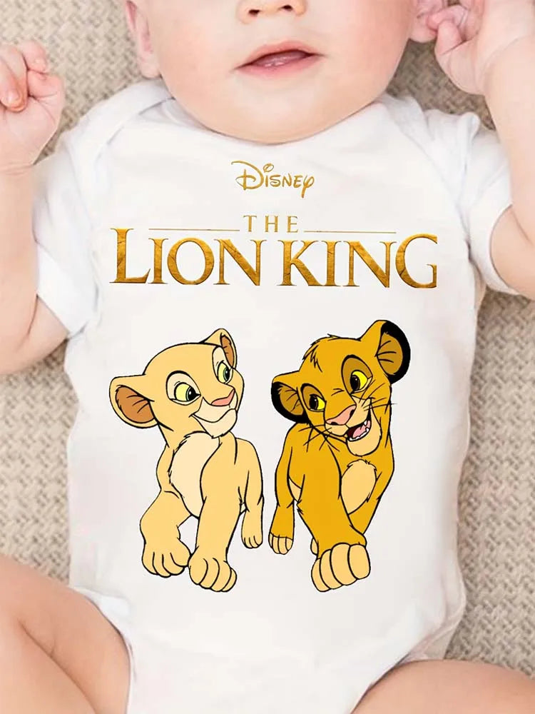 A baby wearing a white bodysuit featuring a Disney The Lion King print of Simba and Mufasa.