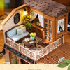 A wooden miniature dollhouse kit of a coffee shop with an open facade and a second-floor terrace view.