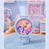 A light blue watch with a pink and purple enamel face featuring a unicorn design, set against a soft background.