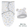 A white cotton newborn swaddle blanket and hat set featuring a pattern of gray rabbits and yellow rainbows.
