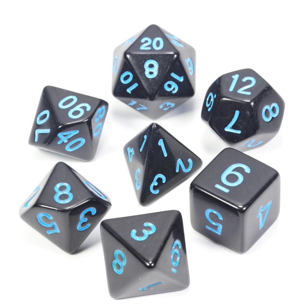 A collection of black acrylic dice showing various numbers and shapes for tabletop role-playing games