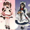 A detailed collectible blind box doll dressed in a pink and white outfit with frills and dark hair.