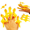 A hand is launching several yellow, chicken-shaped flying toys from a catapult.
