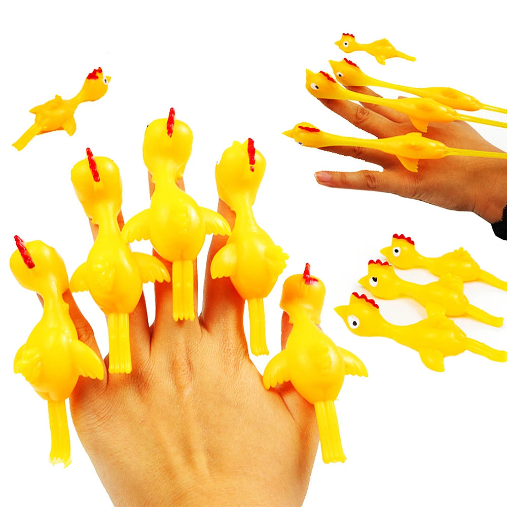 A hand is launching several yellow, chicken-shaped flying toys from a catapult.