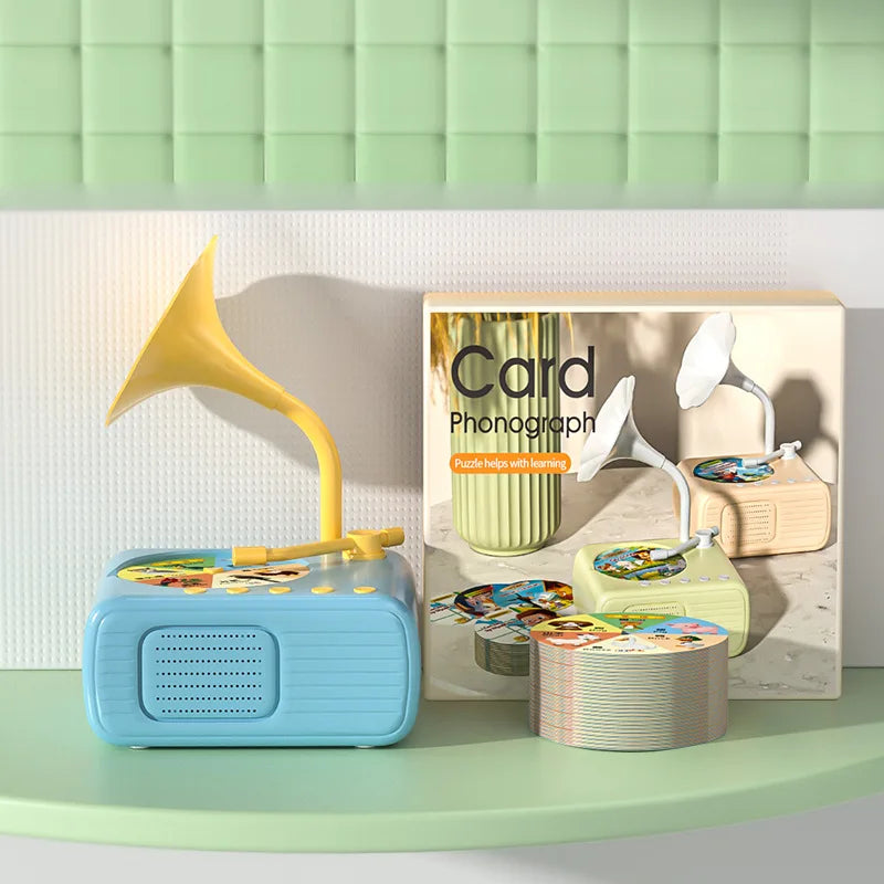 A blue card phonograph toy with a yellow horn and several learning cards displayed on a light-colored surface.