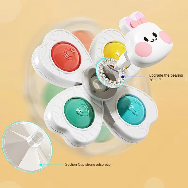 A white spinning suction cup bath toy with multiple colored cups and an upgradeable bearing system.