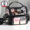 A clear plastic storage bag filled with various hairbrushes and grooming tools inside a black waterproof barber apron.
