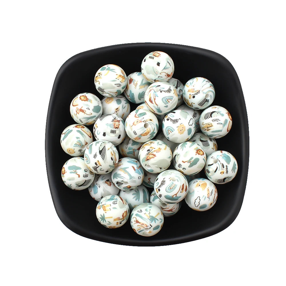 A black dish filled with small white and green printed silicone beads for jewelry making.