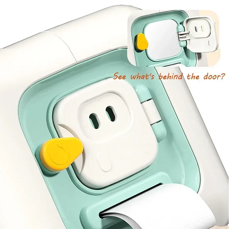A close-up view of a Montessori busy cube toy with a door open, showing internal components and a white cloth.