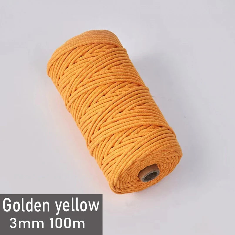 A spool of golden yellow 3mm cotton macrame cord measuring 100 meters.