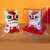 A white and red lion figurine with a shaking head design displayed inside a clear box.