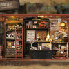 A display of a miniature dollhouse DIY assembly kit featuring cozy bedroom decor set items and various accessories.