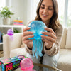 A woman holds a translucent blue jellyfish squish toy with flowing tentacles in her hands.
