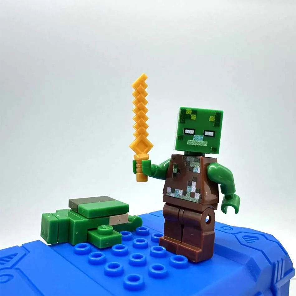 A Minecraft Steve PVC figure set featuring a green character holding an orange staff on a blue base.