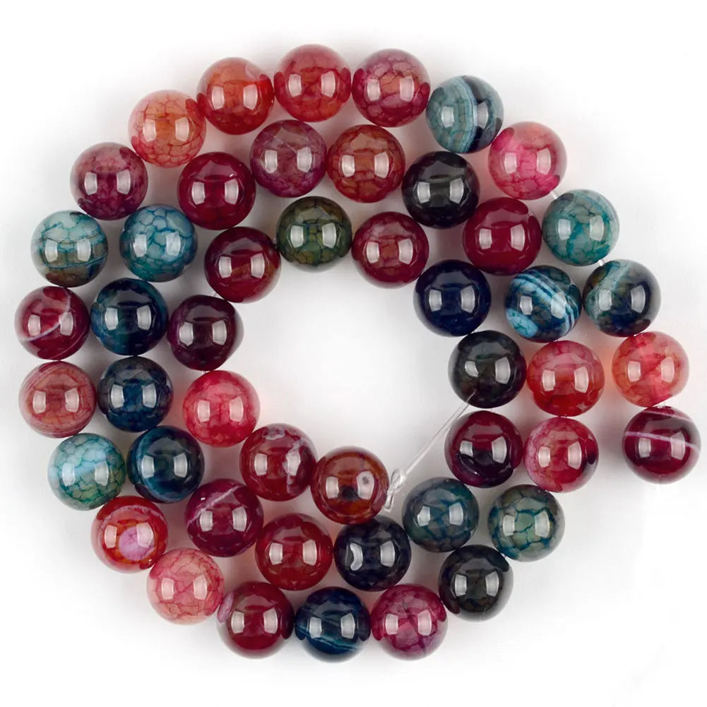 A circular arrangement of polished natural sea sediment jasper and turquoise beads for jewelry making