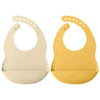 A pair of light beige and yellow waterproof silicone baby bibs with adjustable necks.
