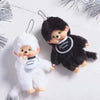 A pair of black and white fuzzy plush cartoon keychains featuring a bear and a rabbit.