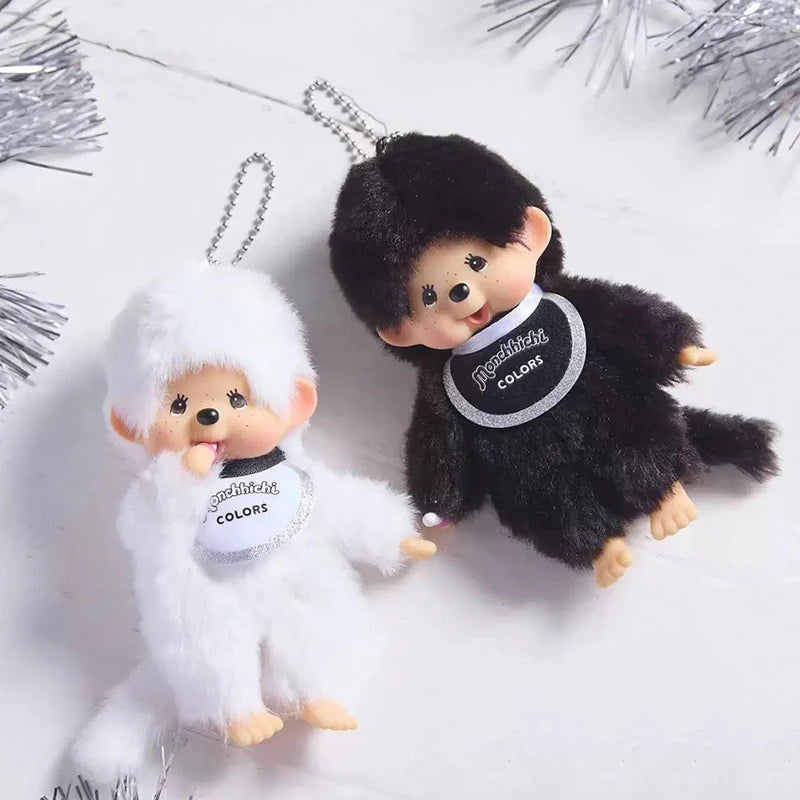 A pair of black and white fuzzy plush cartoon keychains featuring a bear and a rabbit.