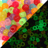 A close-up view of numerous colorful pony beads in various shades including pink, orange, yellow, and green.