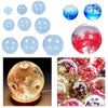 A collection of clear resin casting molds and finished jewelry pieces featuring floral and abstract designs.