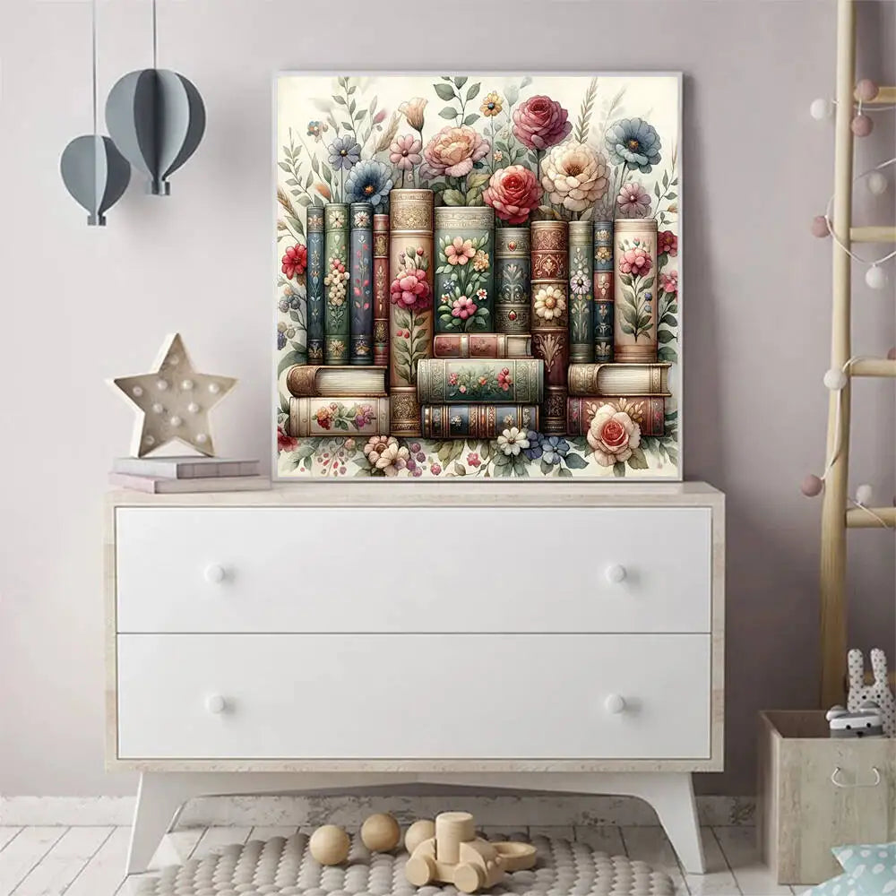 A framed painting featuring a vertical stack of books and floral elements, displayed on a white dresser.