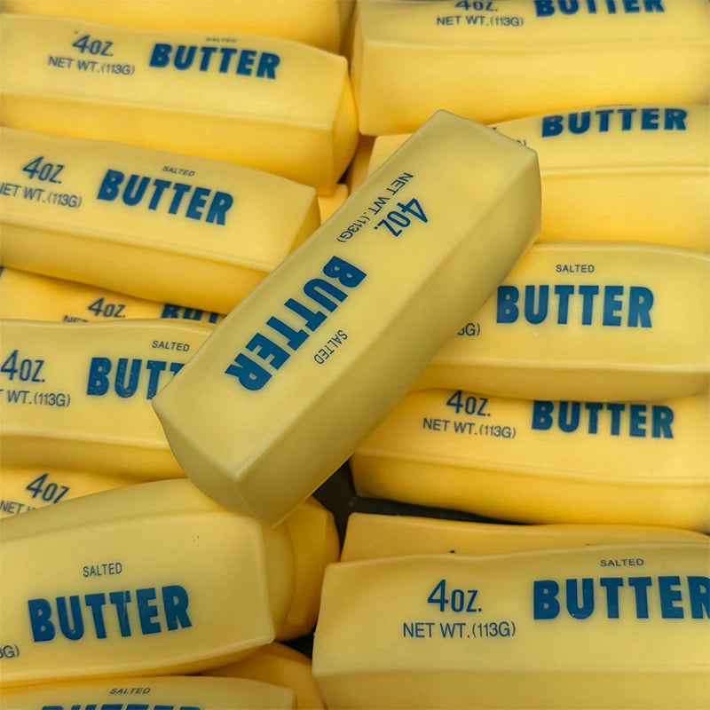 Yellow butter sticks in packaging are shown from above, with labels indicating 4oz salted butter.