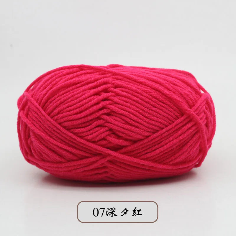 A ball of bright pink pre-dyed milk cotton yarn used for knitting and crochet.