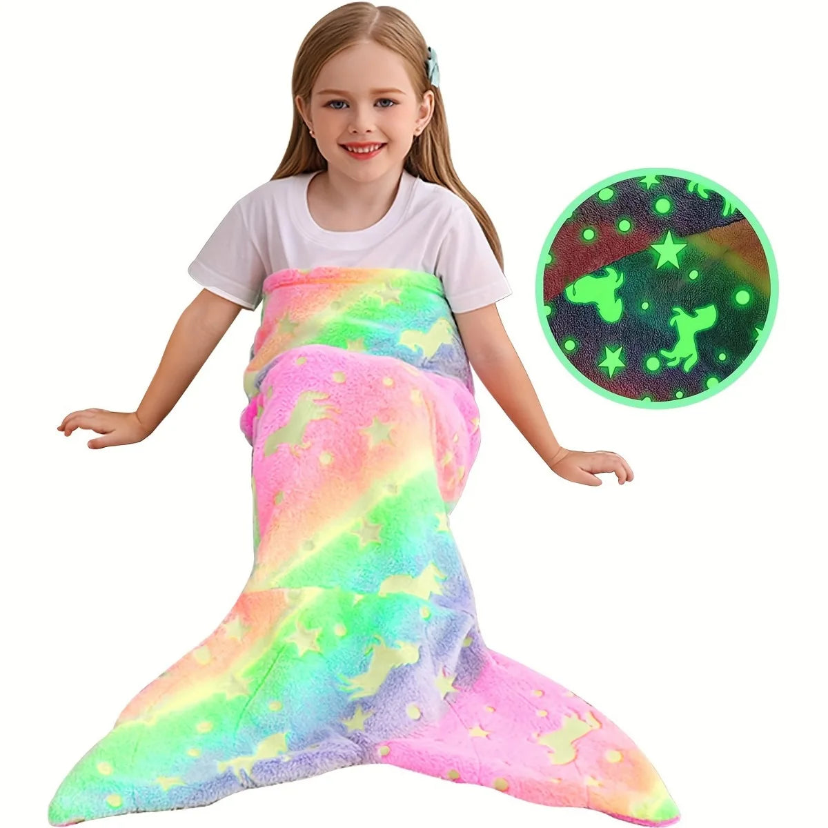 A young girl wearing a glow-in-the-dark mermaid tail blanket and a matching green star-patterned disc.