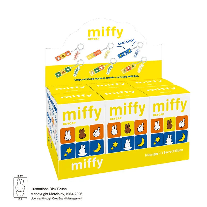 A yellow and white box of Miffy keycap pendants featuring six designs plus a secret edition.
