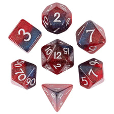 A set of seven polyhedral dice made of glitter resin in various colors and shapes for tabletop role-playing games