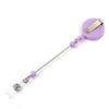 Purple beadable badge reel with a retractable silver clip and clear plastic holder