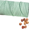 A spool of light green natural cotton macrame rope used for crafts and decor.