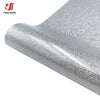 Close-up view of silver glitter heat transfer vinyl material being applied or displayed.
