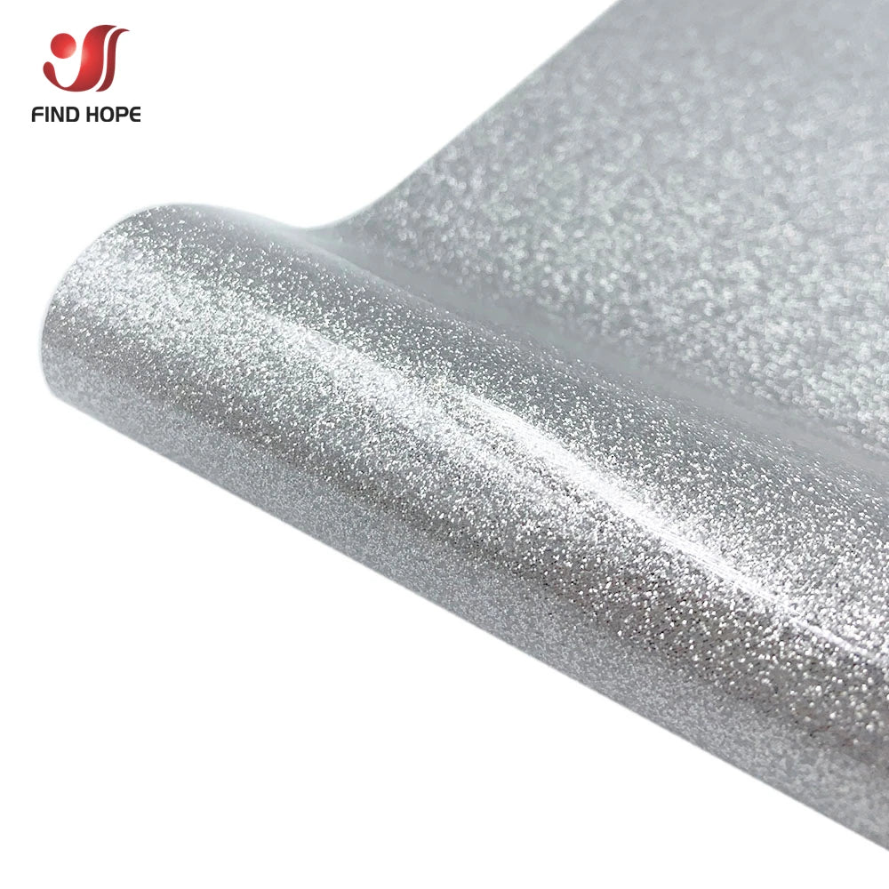 Close-up view of silver glitter heat transfer vinyl material being applied or displayed.